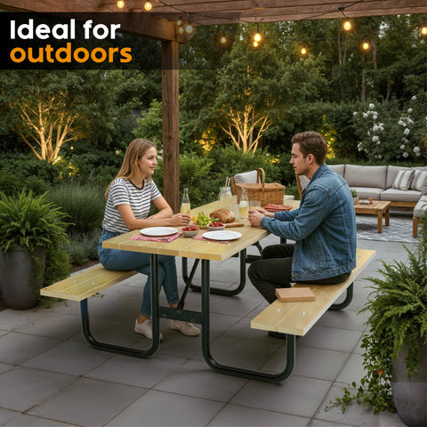 Two people sitting at an outdoor table with food, surrounded by greenery and patio furniture.